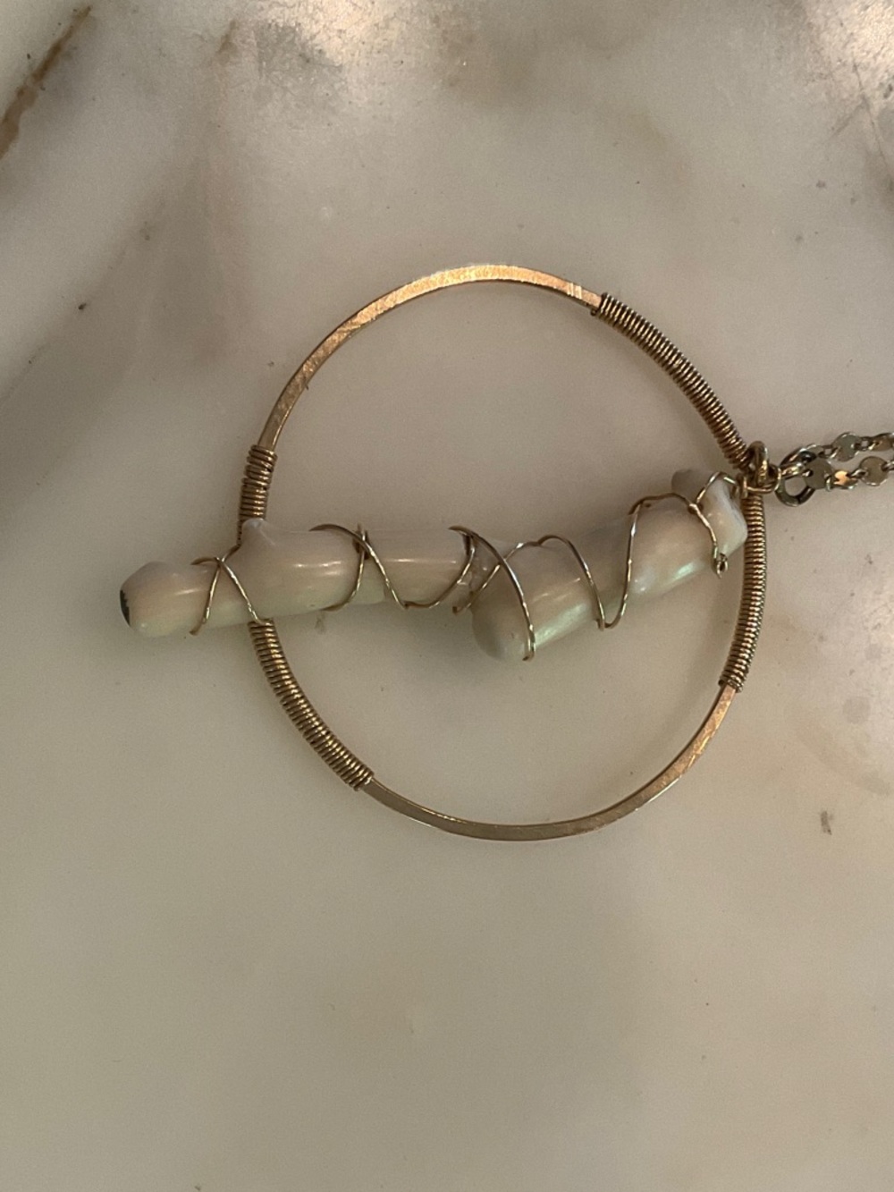 Gold pendant necklace with large white coral .